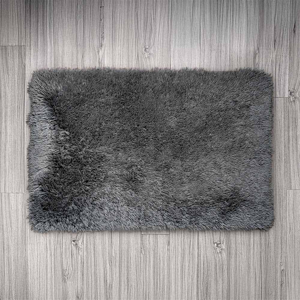 Gray shaggy rug on a wooden floor