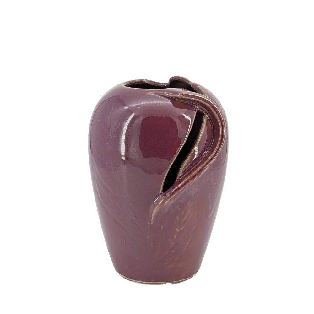 Purple ceramic vase with a leaf design on a white background