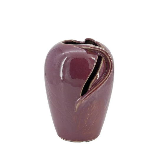 Purple ceramic vase with a leaf design on a white background