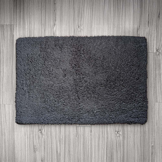 Dark gray doormat on a wooden floor
