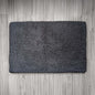 Dark gray doormat on a wooden floor