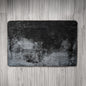 Gray textured rug on a wooden floor