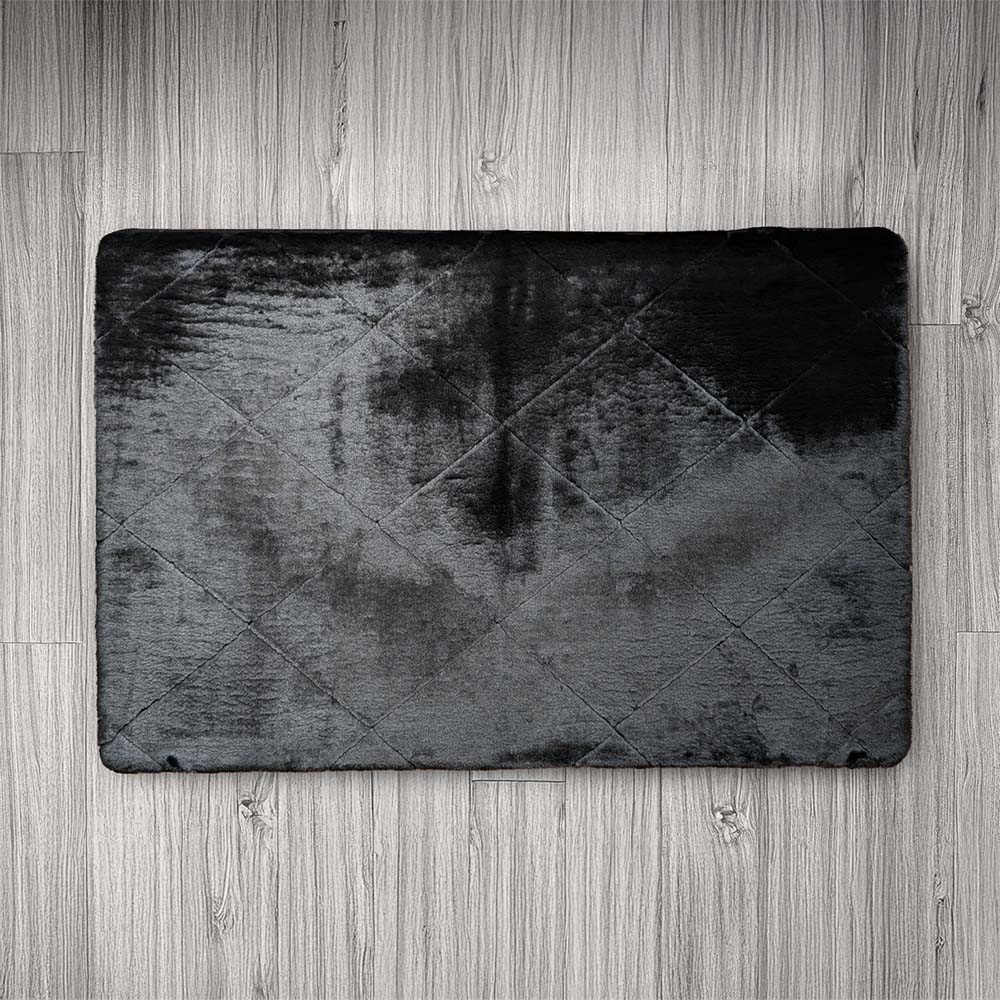 Black textured rug on a wooden floor