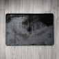 Black textured rug on a wooden floor