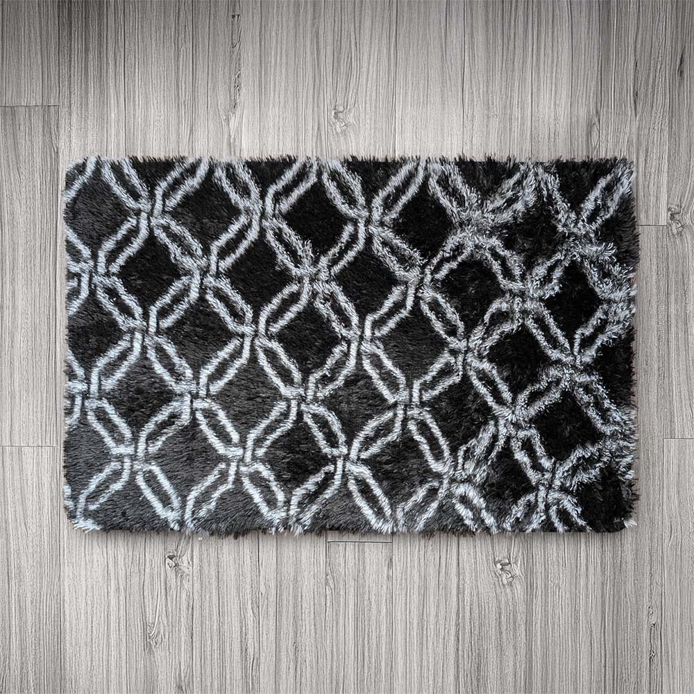 Black and white patterned rug on a wooden floor
