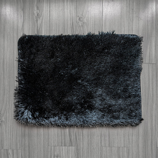 Black shaggy rug on a wooden floor