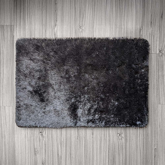 Gray bath mat on a wooden floor