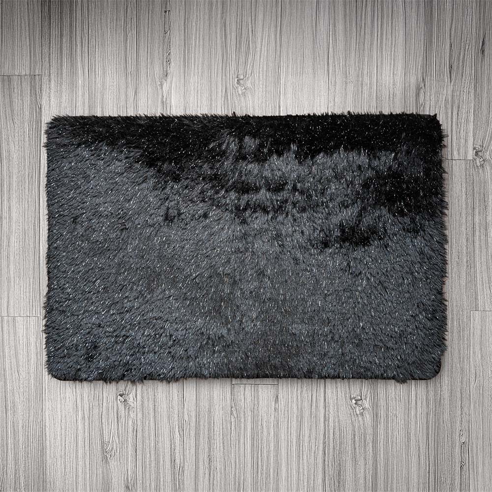 Black and gray doormat on a wooden floor