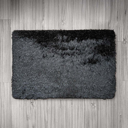 Black and gray doormat on a wooden floor