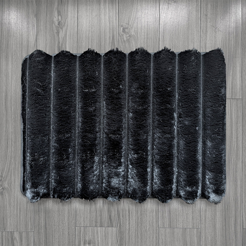 Black rectangular rug on a wooden floor