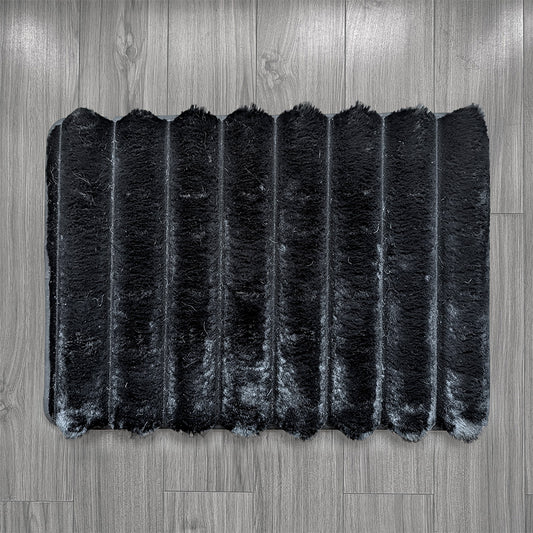 Black rectangular rug on a wooden floor
