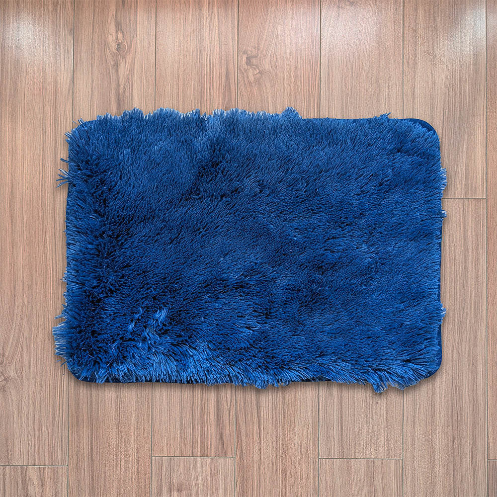 Blue fluffy rug on a wooden floor