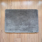 Gray rug on a wooden floor