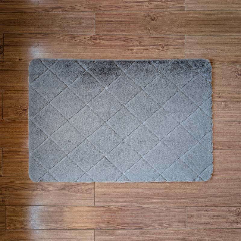 Gray diamond patterned rug on a wooden floor