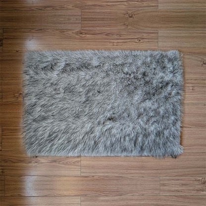 Gray fluffy rug on a wooden floor