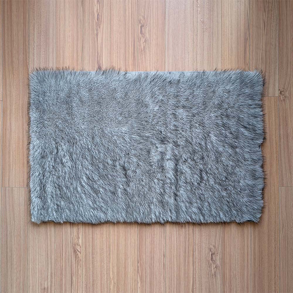 Gray shaggy rug on a wooden floor