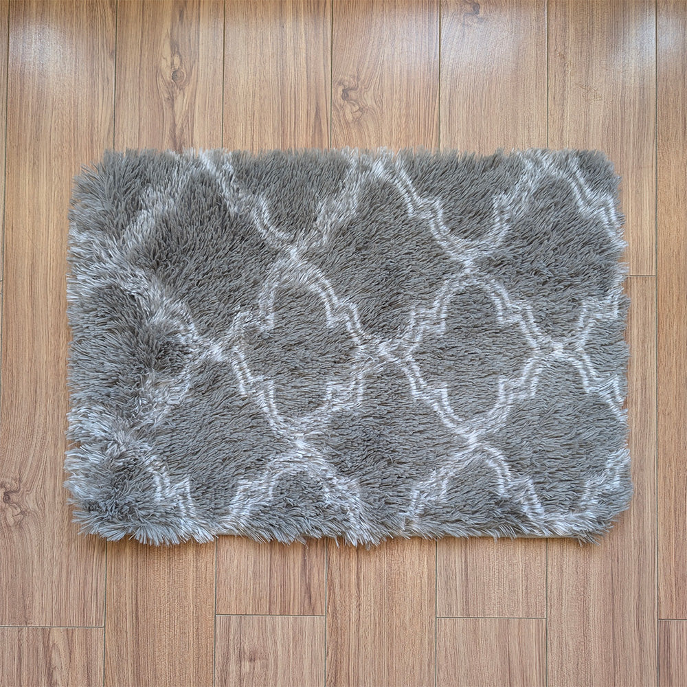 Gray textured rug with white pattern on a wooden floor