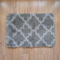 Gray textured rug with white pattern on a wooden floor