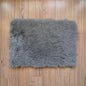Gray shaggy rug on a wooden floor