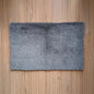 Gray rug on a wooden floor
