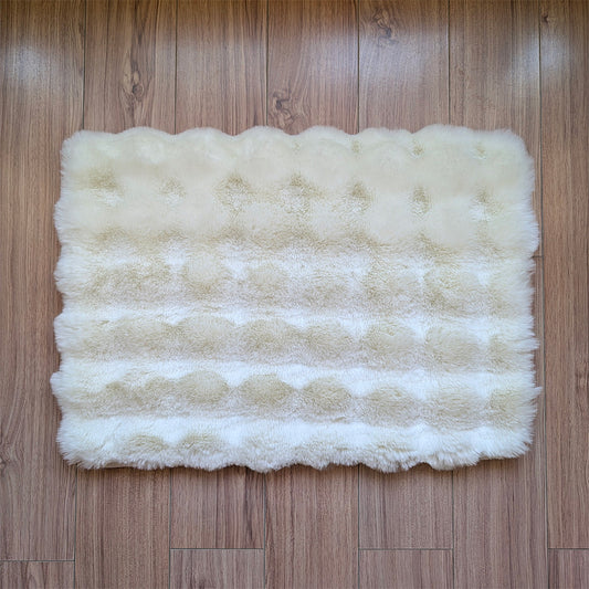 White fluffy rug on a wooden floor