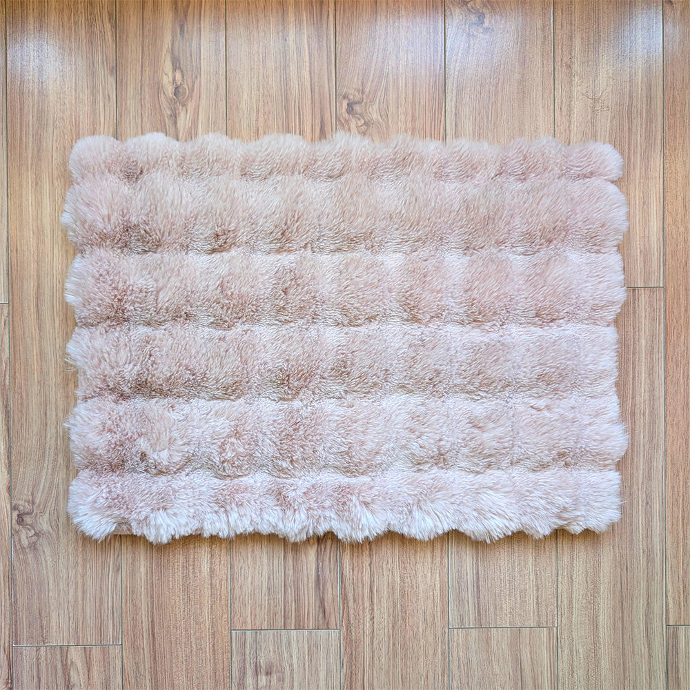 pink fluffy rug on a wooden floor