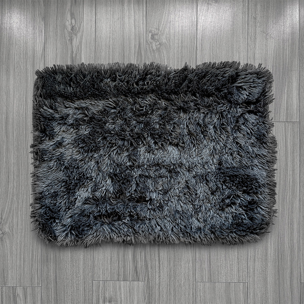 Gray shaggy rug on a wooden floor