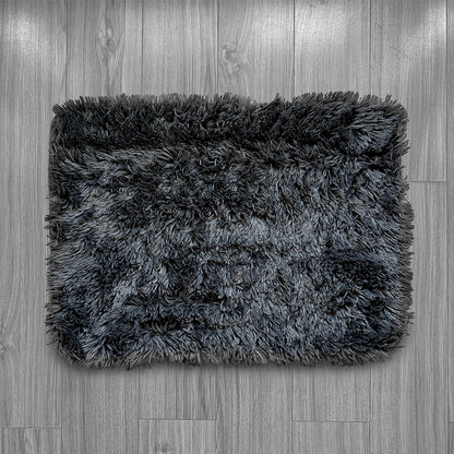 Gray shaggy rug on a wooden floor