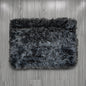 Gray shaggy rug on a wooden floor