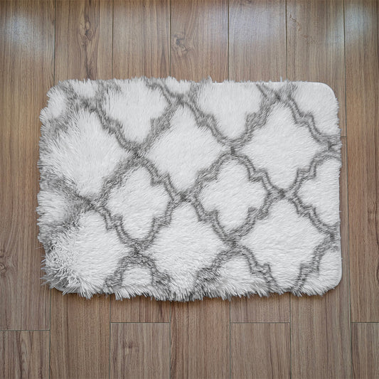 White and gray patterned rug on a wooden floor