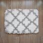 White and gray patterned rug on a wooden floor