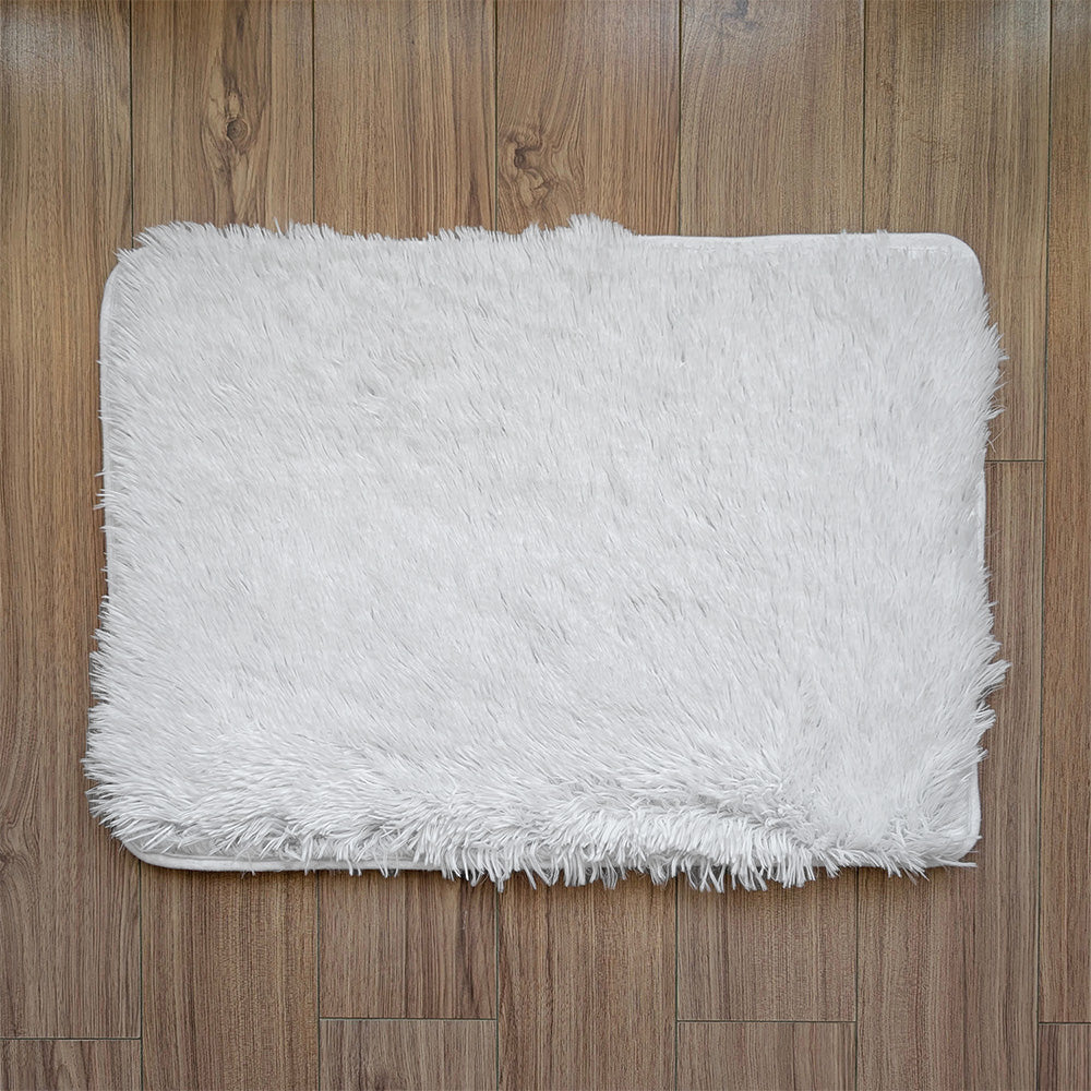 White fluffy rug on a wooden floor