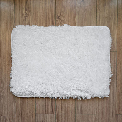 White fluffy rug on a wooden floor