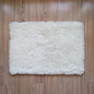White fluffy rug on a wooden floor
