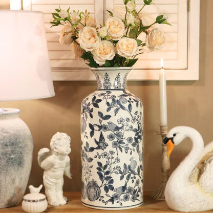 ceramic blue floral vase with roses on a wooden table