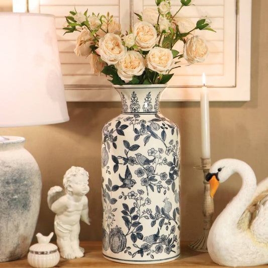 ceramic blue floral vase with roses on a wooden table