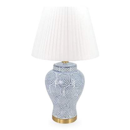 Decorative table lamp with a white pleated shade on a white background