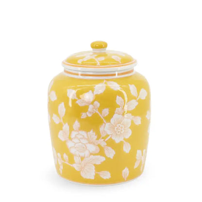 Yellow ceramic jar with floral patterns on a white background