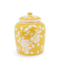 Yellow ceramic jar with floral patterns on a white background