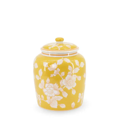 Yellow ceramic jar with floral design on a white background