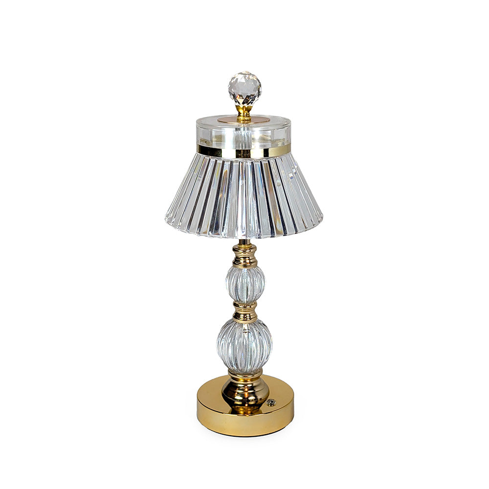 Decorative table lamp with crystal and gold accents on a white background