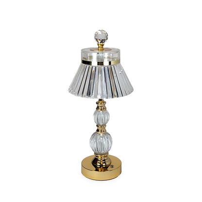 Decorative table lamp with crystal and gold accents on a white background