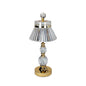 Decorative table lamp with crystal and gold accents on a white background